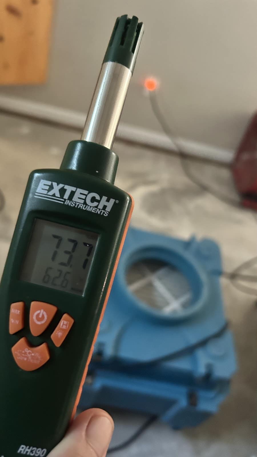 Moisture meter being used during a water-damage inspection